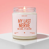 a candle labeled "My Last Nerve" with a flame, placed on a white pedestal against a pink background.