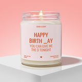A white candle with a lit flame, labeled as a birthday candle, against a pink background.